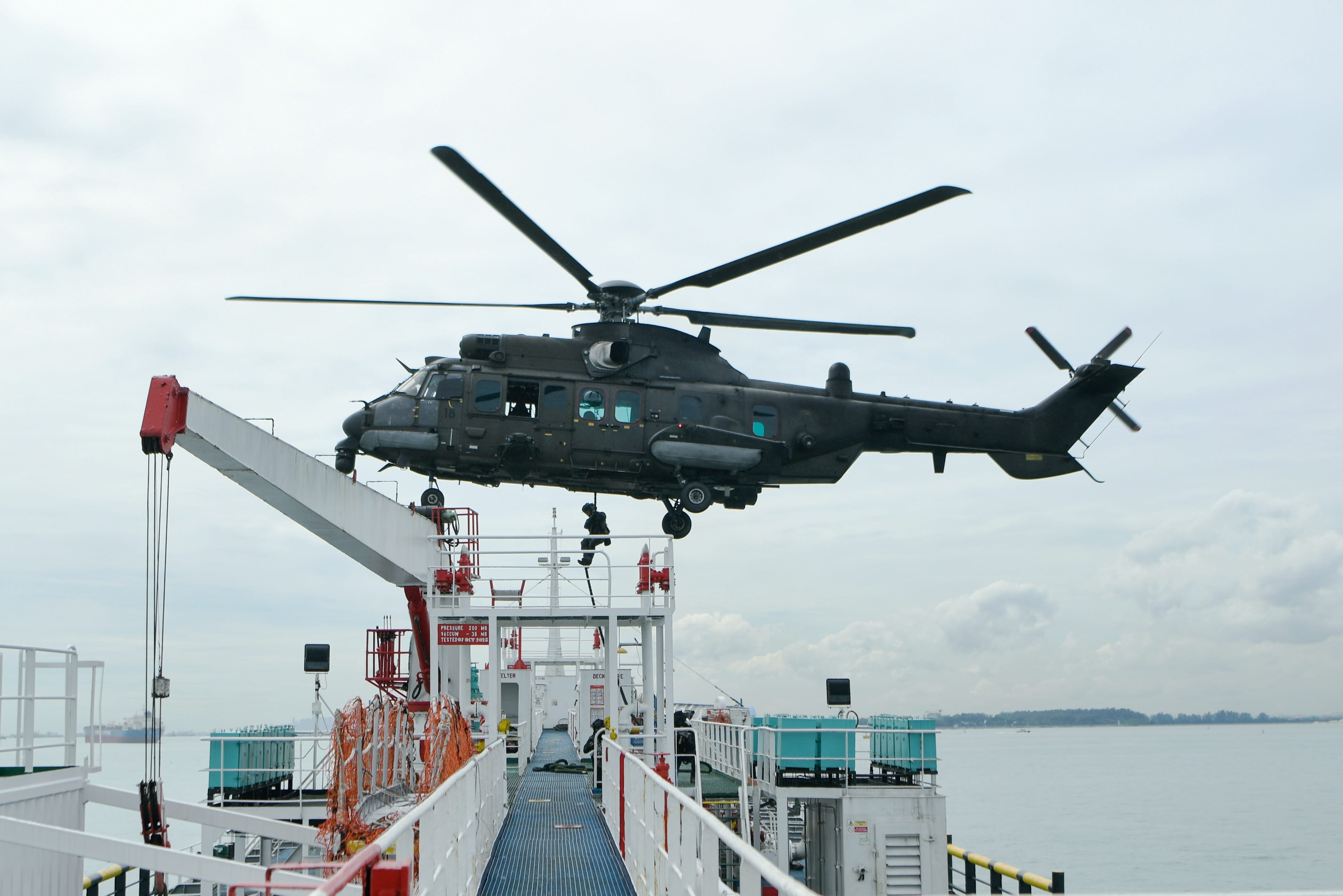 The Singapore Armed Forces’ (SAF) Special Operations Task Force (SOTF) roping down from the H225M helicopter onto the hijacked vessel.